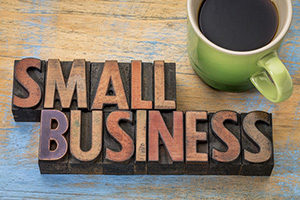 Business Accounting: a woodcut "Small Business" sign and a cup of coffee
